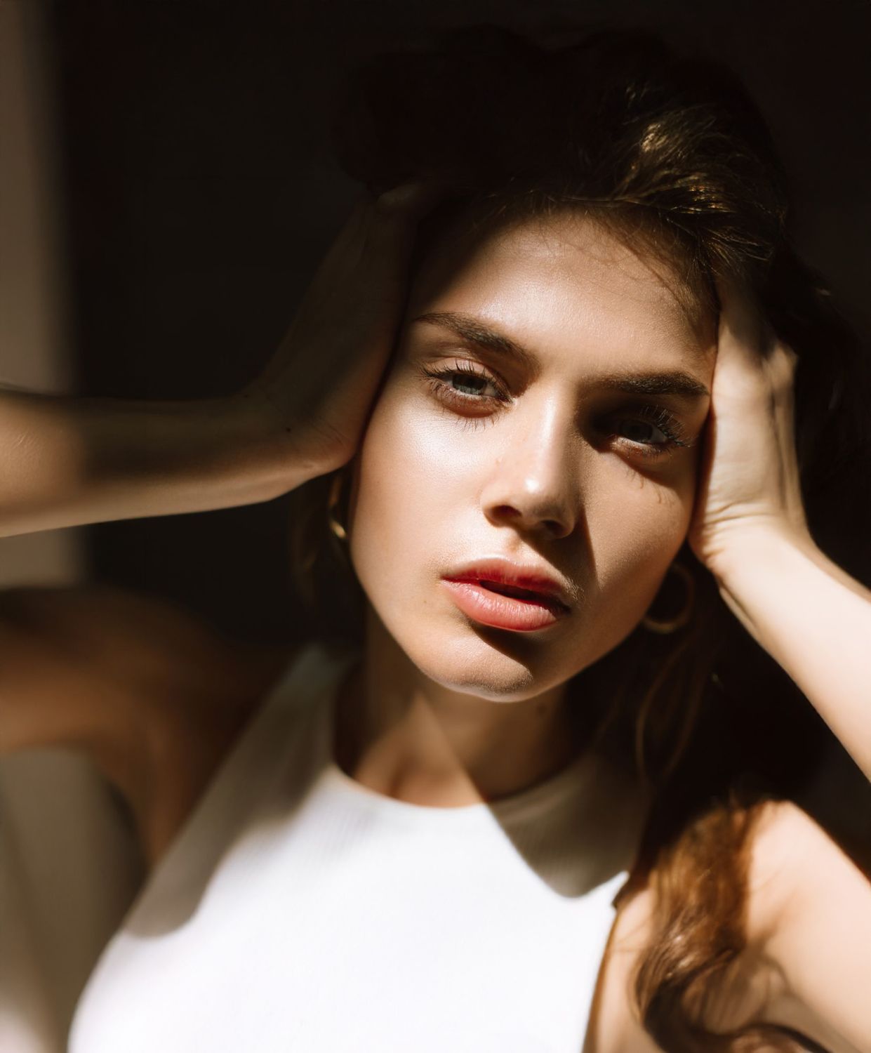 Farmington chin augmentation model with dramatic lighting and expression.