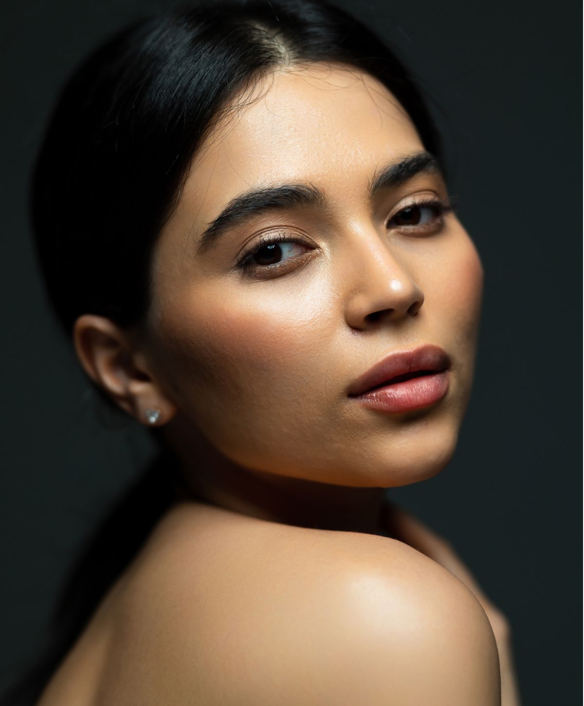 Avon microdermabrasion model with glowing skin and natural makeup.