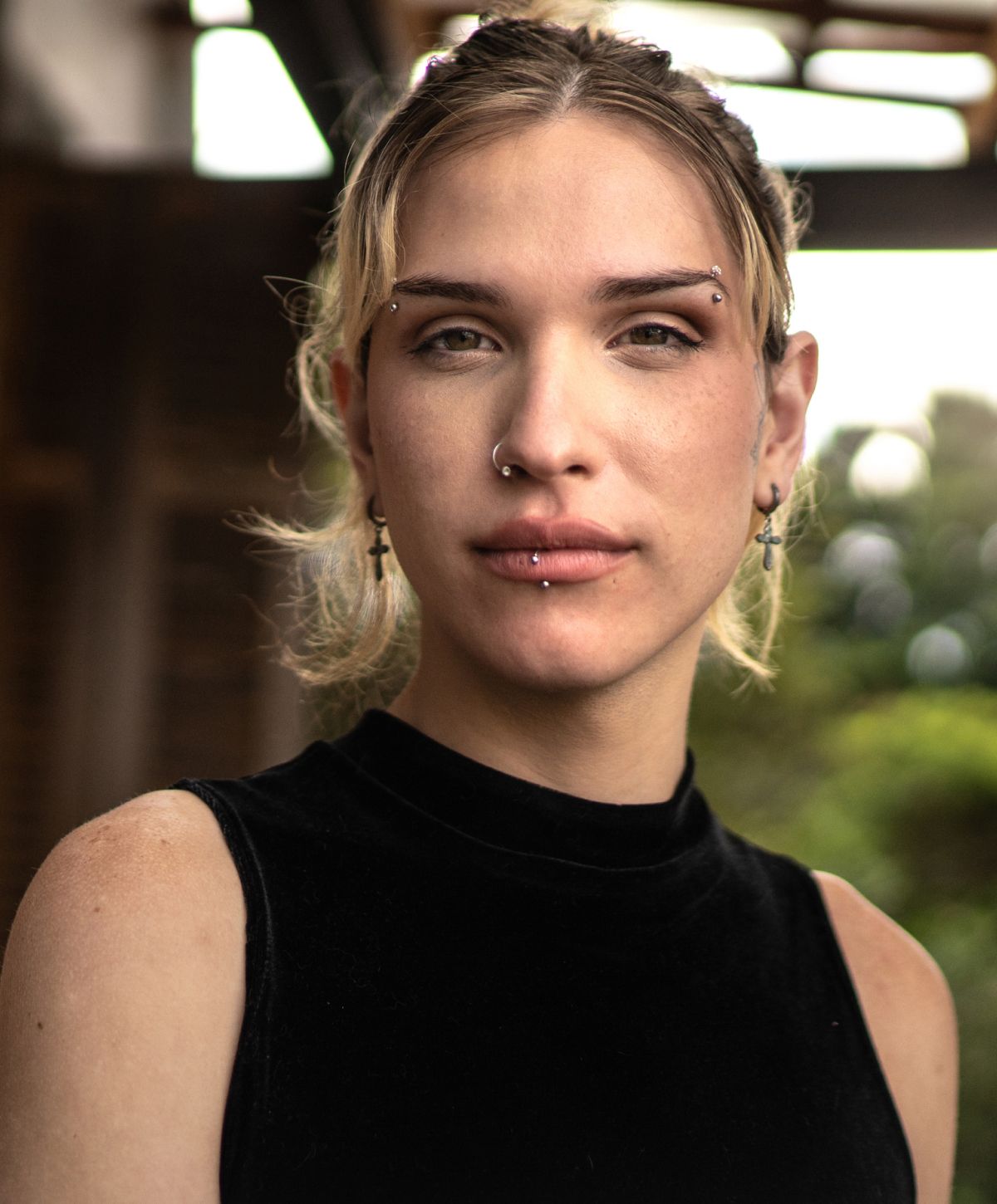 Avon FFS model with piercings in soft natural light.