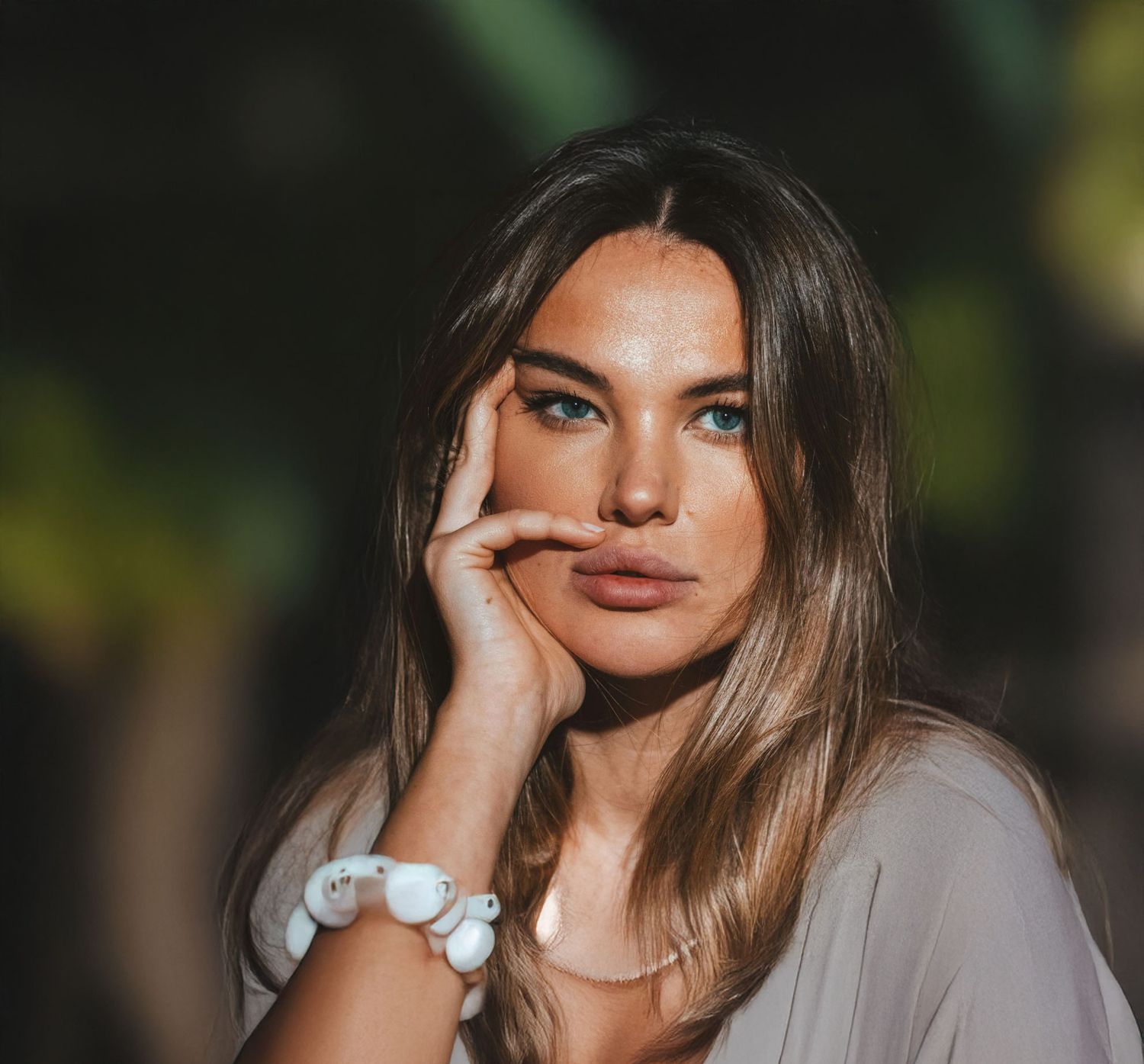 Avon med spa model with long hair posing thoughtfully outdoors after appointment with a Connecticut plastic surgeon.