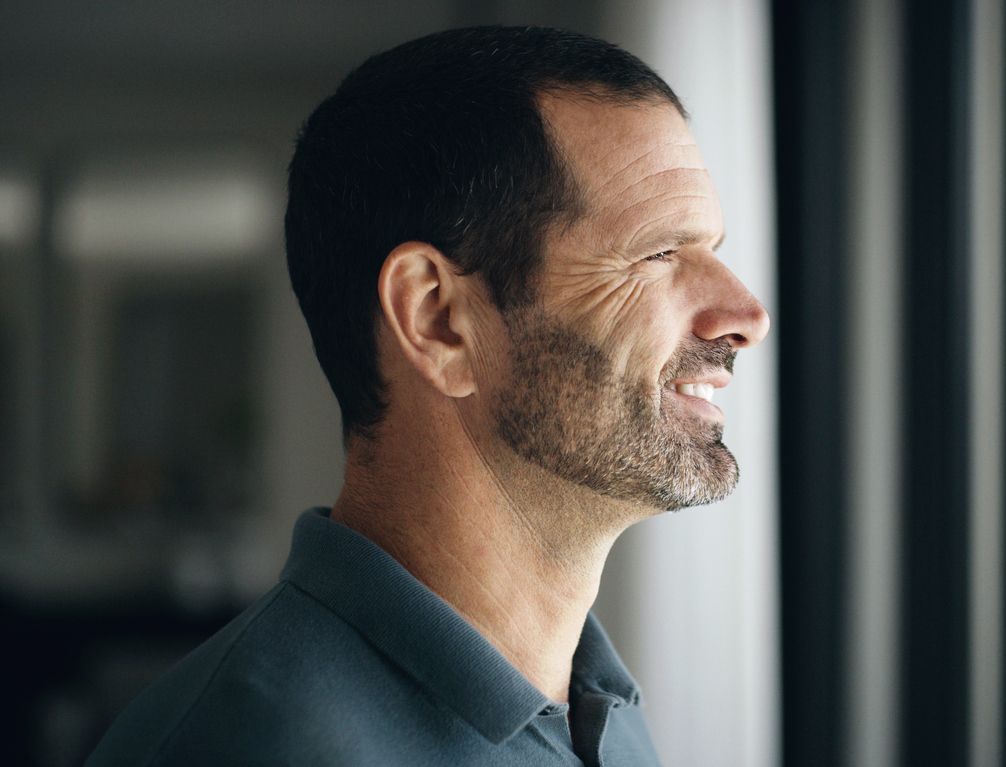 Farmington ear reshaping model smiling while looking out a window.