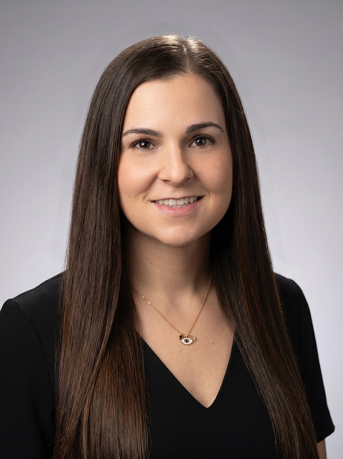 Professional headshot of a smiling woman.