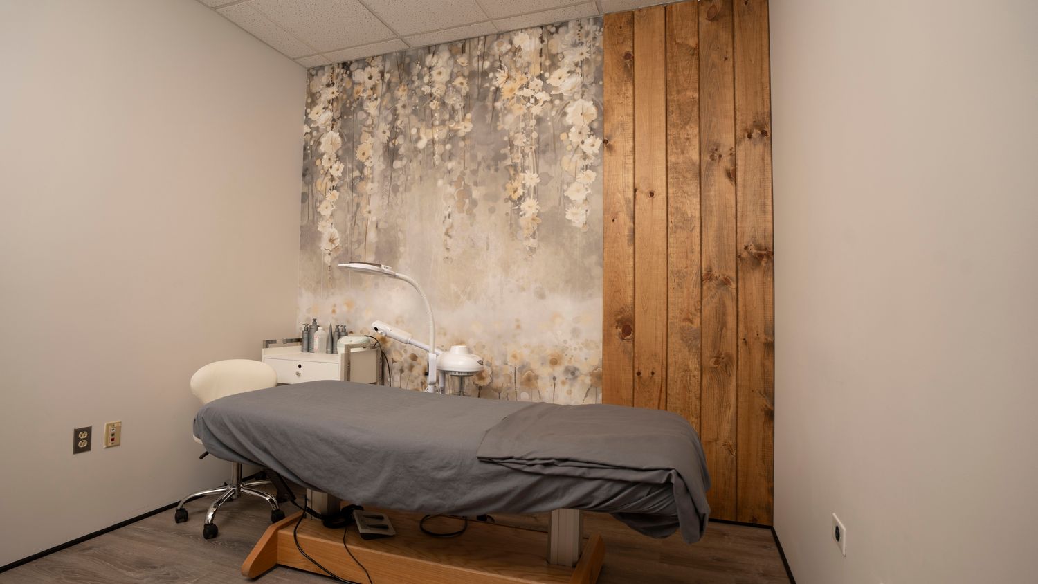 Spa treatment room with floral wall decor.